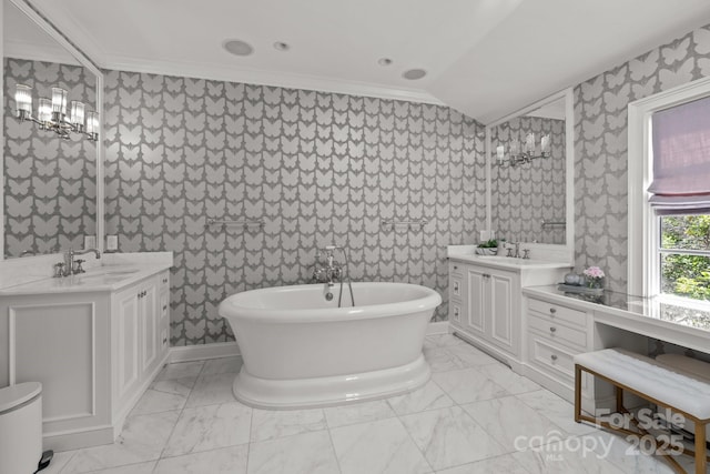 1625 Bibury Ln, Charlotte, NC 28211 - full bathroom featuring ornamental molding, marble look tile flooring, a freestanding tub, two vanities, and wallpapered walls