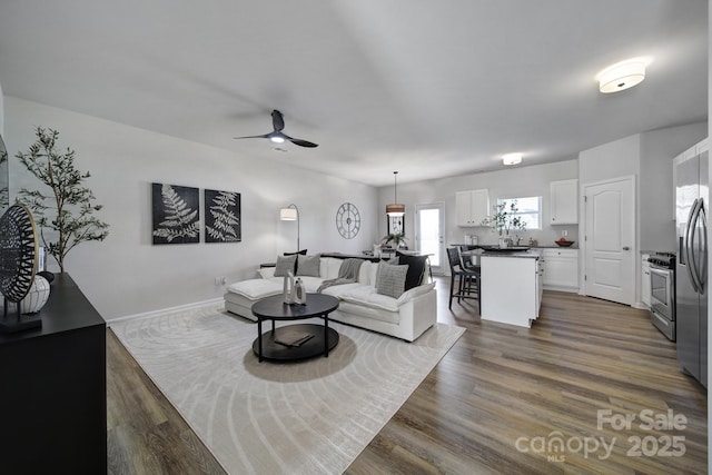 149 Briana Marie Way, Indian Trail, NC 28079 - living area with ceiling fan, dark wood-type flooring, and baseboards