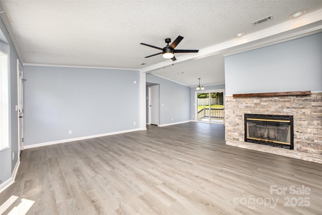 4750 Enochville Rd, Kannapolis, NC 28081 - unfurnished living room featuring a textured ceiling, crown molding, a ceiling fan, a stone fireplace, and vaulted ceiling