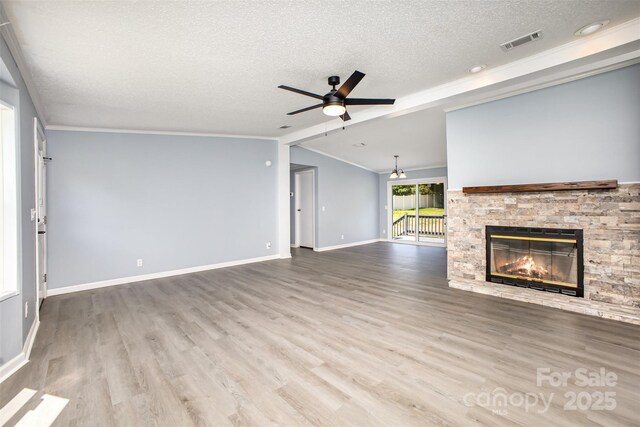 4750 Enochville Rd, Kannapolis, NC 28081 - unfurnished living room with a textured ceiling, ceiling fan, crown molding, a fireplace, and wood finished floors