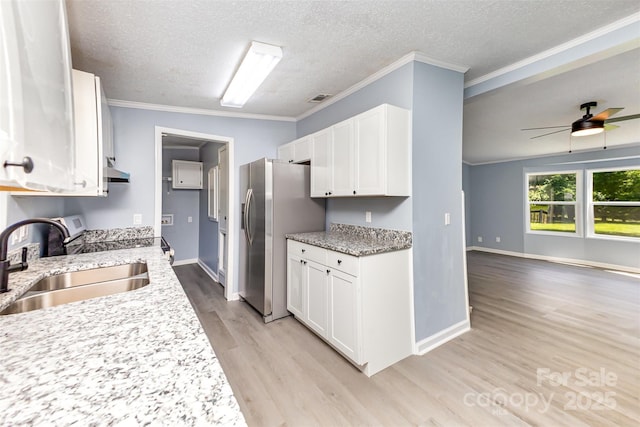 4750 Enochville Rd, Kannapolis, NC 28081 - kitchen with a sink, stainless steel fridge with ice dispenser, light wood-style floors, white cabinetry, and a textured ceiling