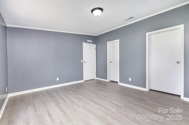 4750 Enochville Rd, Kannapolis, NC 28081 - unfurnished bedroom featuring ornamental molding, wood finished floors, a textured ceiling, and baseboards