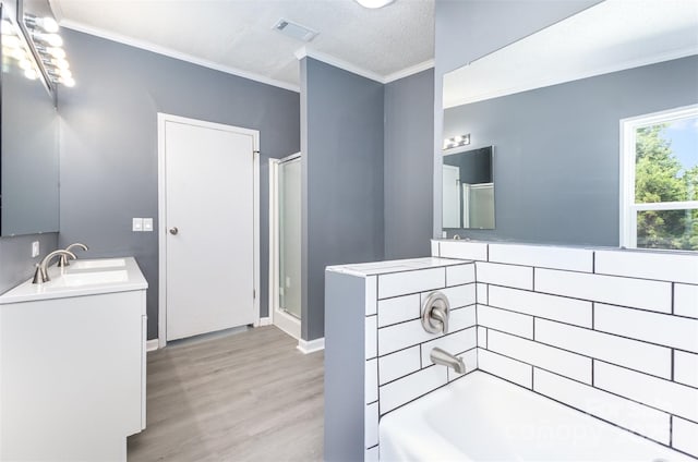 4750 Enochville Rd, Kannapolis, NC 28081 - bathroom with wood finished floors, crown molding, a bathtub, a shower with door, and vanity
