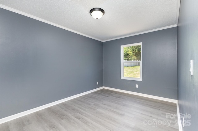 4750 Enochville Rd, Kannapolis, NC 28081 - spare room featuring wood finished floors, ornamental molding, baseboards, and a textured ceiling