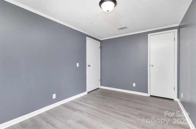 4750 Enochville Rd, Kannapolis, NC 28081 - unfurnished bedroom featuring a textured ceiling, wood finished floors, baseboards, and ornamental molding
