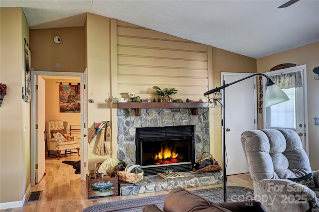 74 Sunflower Ln, Waynesville, NC 28785 - living room featuring wood finished floors, a stone fireplace, and lofted ceiling