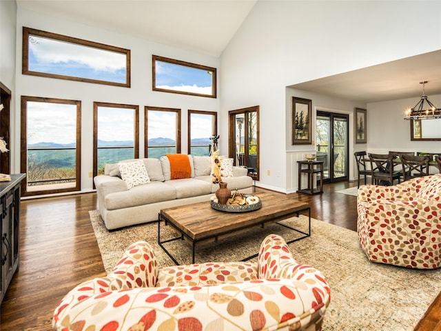 4344 Eagles Nest Rd, Waynesville, NC 28786 - living room featuring dark wood-type flooring, a chandelier, high vaulted ceiling, and baseboards