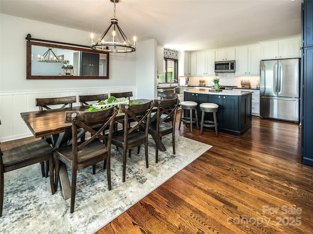 4344 Eagles Nest Rd, Waynesville, NC 28786 - dining space with a chandelier and dark wood-style flooring
