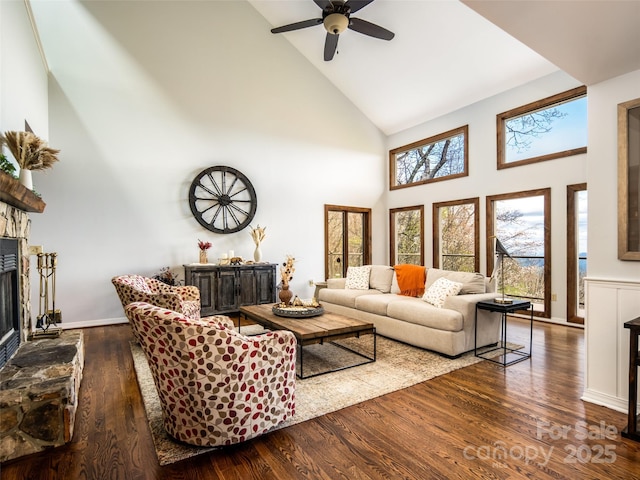 4344 Eagles Nest Rd, Waynesville, NC 28786 - living area featuring high vaulted ceiling, a stone fireplace, ceiling fan, and wood finished floors