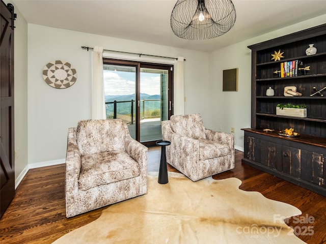 4344 Eagles Nest Rd, Waynesville, NC 28786 - sitting room featuring wood finished floors, a barn door, and baseboards