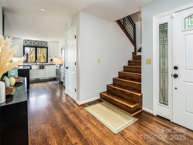 4344 Eagles Nest Rd, Waynesville, NC 28786 - foyer featuring dark wood-type flooring, stairs, and baseboards