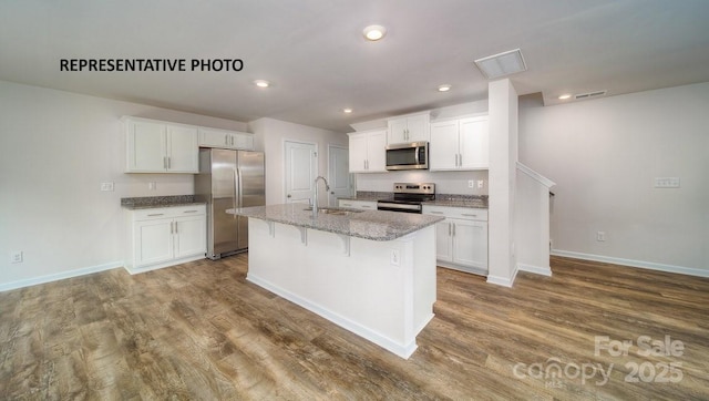 921 Two Brothers Ln, York, SC 29745 - kitchen with appliances with stainless steel finishes, white cabinets, an island with sink, and recessed lighting