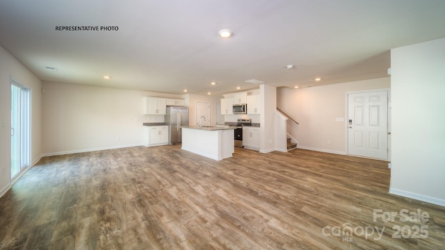 921 Two Brothers Ln, York, SC 29745 - unfurnished living room featuring stairs, recessed lighting, and wood finished floors
