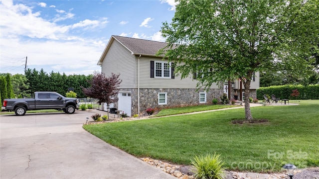 5750 Ellenwood Dr, Granite Falls, NC 28630 - view of front facade with stone siding, an attached garage, a front yard, and concrete driveway