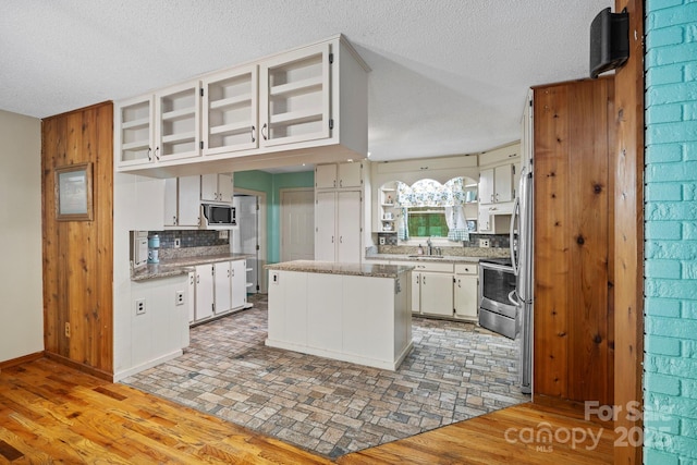 14518 Big Laurel Rd, Mars Hill, NC 28754 - kitchen with a sink, stainless steel appliances, backsplash, a textured ceiling, and white cabinets
