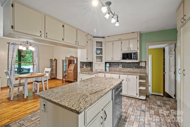 14518 Big Laurel Rd, Mars Hill, NC 28754 - kitchen featuring black microwave, backsplash, brick patterned floors, a kitchen island, and light stone countertops