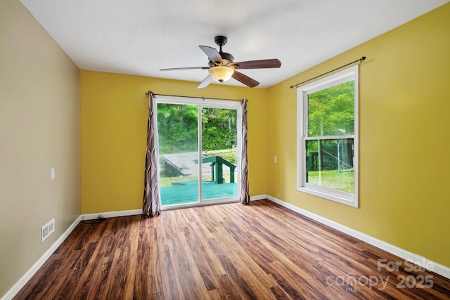 14518 Big Laurel Rd, Mars Hill, NC 28754 - empty room featuring a ceiling fan, healthy amount of natural light, wood finished floors, and baseboards