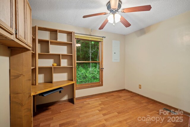 14518 Big Laurel Rd, Mars Hill, NC 28754 - unfurnished office featuring electric panel, a textured ceiling, light wood-style floors, ceiling fan, and baseboards