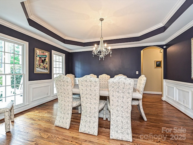 2406 Tarleton Twins Ter, Charlotte, NC 28270 - dining area with a chandelier, a raised ceiling, wood finished floors, crown molding, and arched walkways