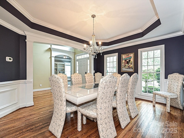2406 Tarleton Twins Ter, Charlotte, NC 28270 - dining space featuring wood finished floors, a chandelier, crown molding, plenty of natural light, and wainscoting