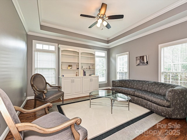 2406 Tarleton Twins Ter, Charlotte, NC 28270 - living area with dark wood-style floors, a ceiling fan, baseboards, ornamental molding, and a raised ceiling