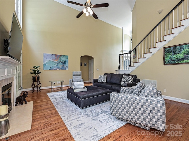 2406 Tarleton Twins Ter, Charlotte, NC 28270 - living area featuring arched walkways, high vaulted ceiling, ceiling fan, wood finished floors, and stairway