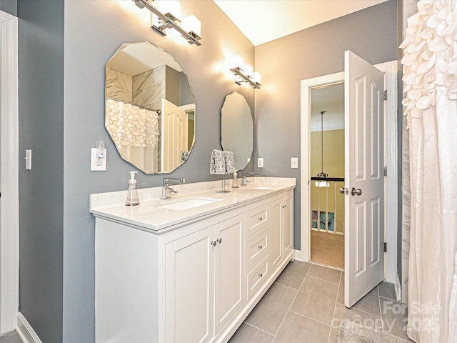 2406 Tarleton Twins Ter, Charlotte, NC 28270 - full bathroom with double vanity, tile patterned flooring, and baseboards