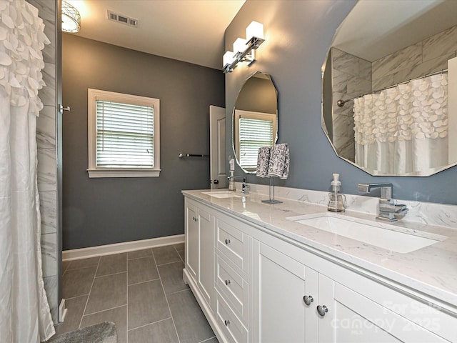 2406 Tarleton Twins Ter, Charlotte, NC 28270 - full bathroom featuring double vanity, tile patterned floors, baseboards, and a shower with shower curtain