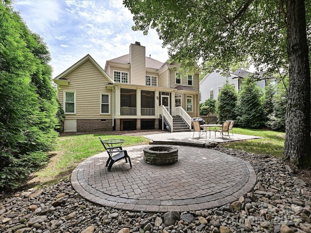 2406 Tarleton Twins Ter, Charlotte, NC 28270 - back of property featuring a fire pit, a chimney, a patio, a sunroom, and a yard
