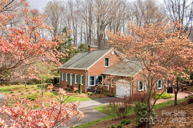 303 Wade E Vannoy Dr, West Jefferson, NC 28694 - view of front facade with asphalt driveway, brick siding, a chimney, and a shingled roof