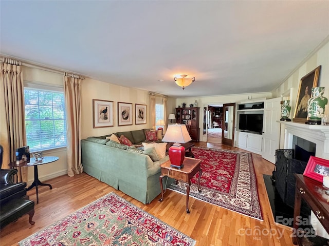 303 Wade E Vannoy Dr, West Jefferson, NC 28694 - living room with light wood-style flooring and a fireplace with flush hearth