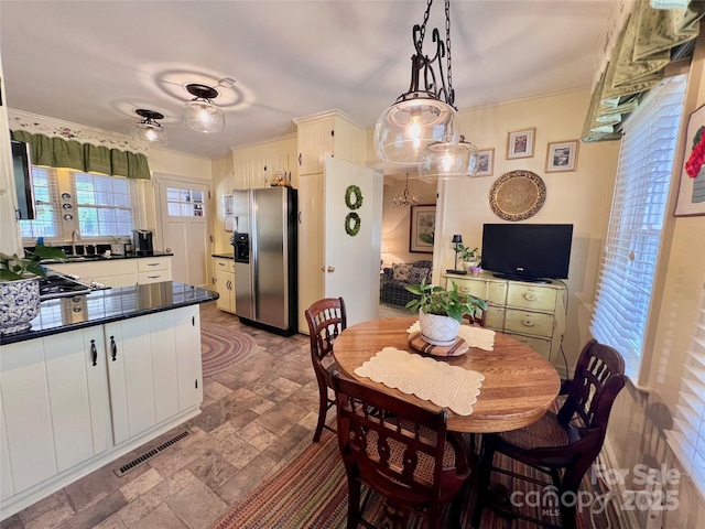 303 Wade E Vannoy Dr, West Jefferson, NC 28694 - dining space with stone finish floors and crown molding