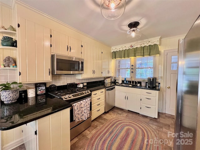 303 Wade E Vannoy Dr, West Jefferson, NC 28694 - kitchen with stainless steel appliances, crown molding, a sink, dark countertops, and stone finish flooring