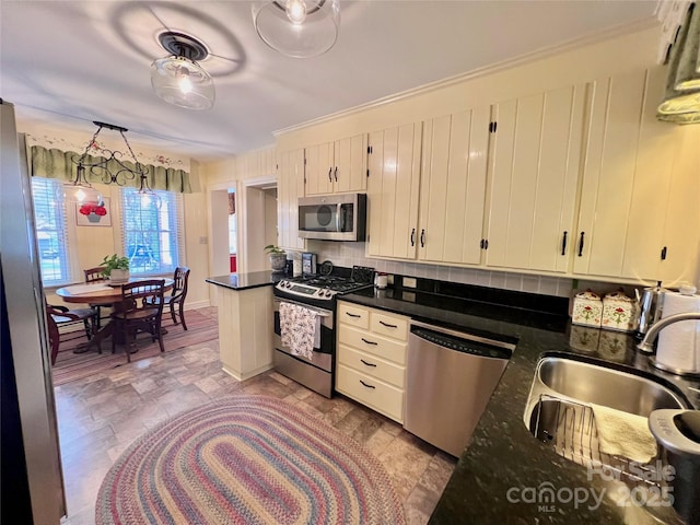 303 Wade E Vannoy Dr, West Jefferson, NC 28694 - kitchen featuring stainless steel appliances, a sink, tasteful backsplash, light stone finish floors, and crown molding