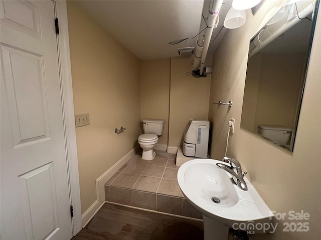 303 Wade E Vannoy Dr, West Jefferson, NC 28694 - half bathroom featuring toilet, a sink, and baseboards