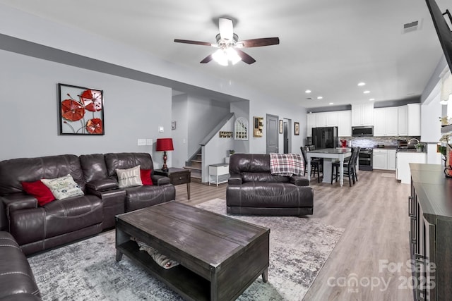 1725 Mill Creek Ln SW, Concord, NC 28025 - living room featuring stairway, ceiling fan, light wood-style floors, and recessed lighting