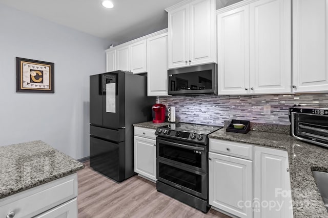 1725 Mill Creek Ln SW, Concord, NC 28025 - kitchen featuring double oven range, freestanding refrigerator, backsplash, and white cabinetry