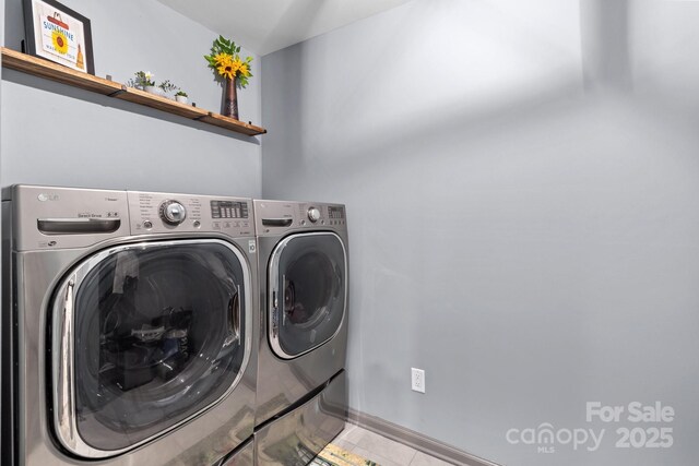 1725 Mill Creek Ln SW, Concord, NC 28025 - laundry area with washer and dryer, tile patterned floors, and baseboards