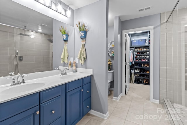 1725 Mill Creek Ln SW, Concord, NC 28025 - full bath with a shower stall, toilet, tile patterned flooring, double vanity, and baseboards