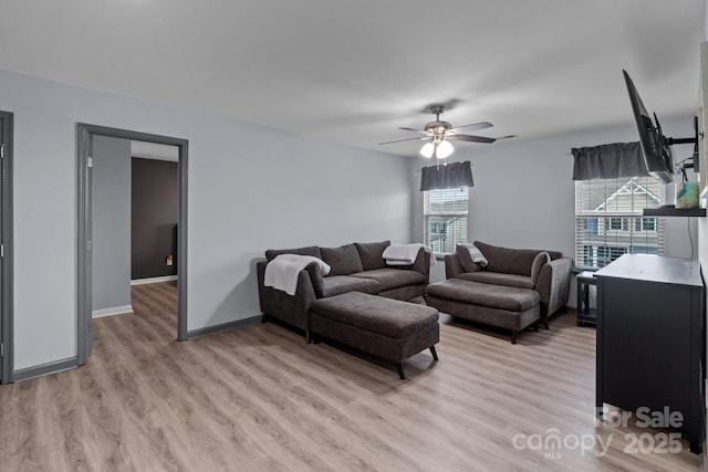 1725 Mill Creek Ln SW, Concord, NC 28025 - living room featuring light wood-style floors, a ceiling fan, and baseboards