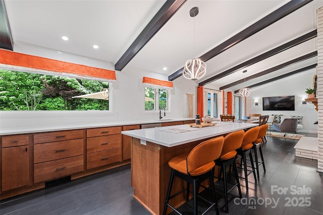 225 Valley View Ter, Waynesville, NC 28786 - kitchen with brown cabinets, light countertops, a center island, open floor plan, and a kitchen breakfast bar