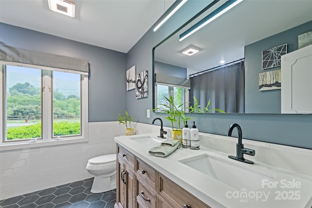225 Valley View Ter, Waynesville, NC 28786 - bathroom with tile walls, double vanity, tile patterned floors, wainscoting, and curtained shower