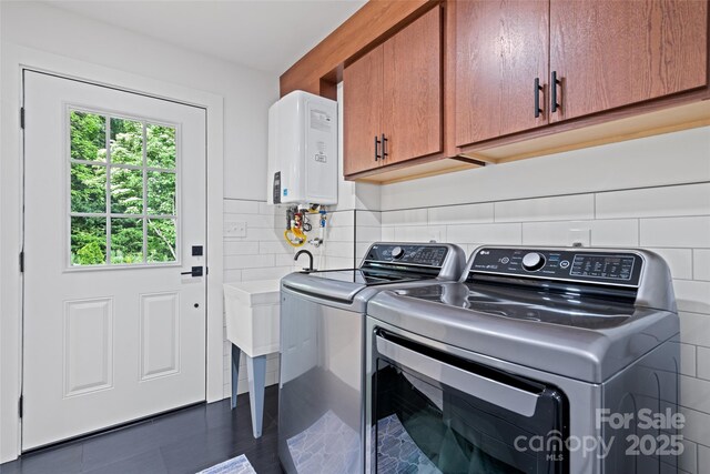 225 Valley View Ter, Waynesville, NC 28786 - washroom featuring cabinet space, water heater, and washer and clothes dryer