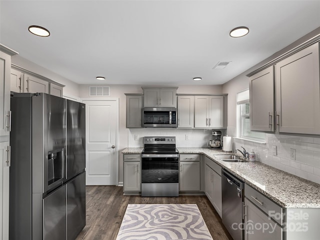 32 Benedict Ln, Weaverville, NC 28787 - kitchen with appliances with stainless steel finishes, gray cabinetry, backsplash, a sink, and light stone countertops