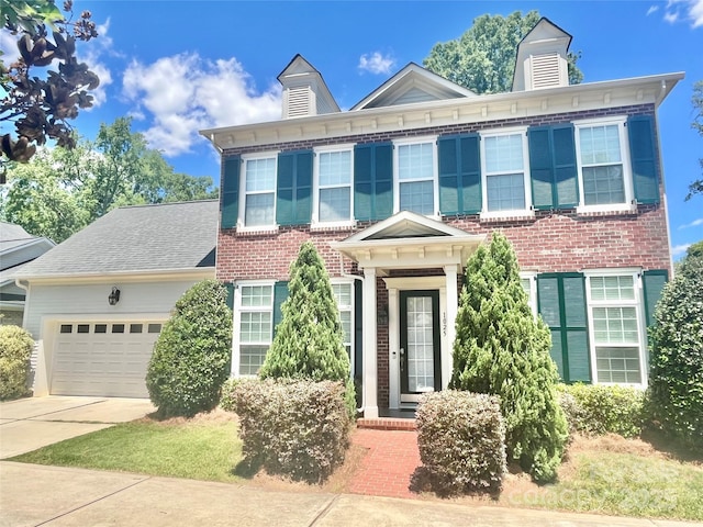 1025 N Sharon Amity Rd, Charlotte, NC 28211 - italianate home featuring an attached garage, concrete driveway, and brick siding