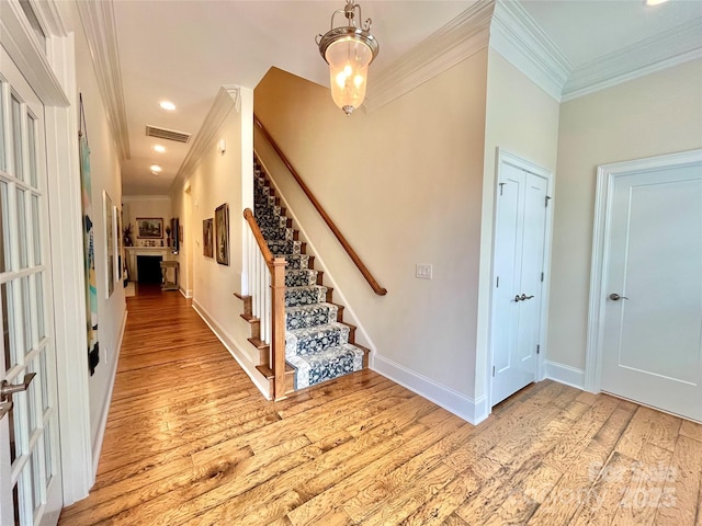 1025 N Sharon Amity Rd, Charlotte, NC 28211 - entrance foyer featuring ornamental molding, light wood-type flooring, stairway, baseboards, and recessed lighting