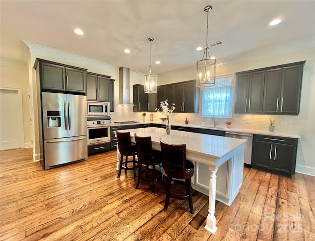 1025 N Sharon Amity Rd, Charlotte, NC 28211 - kitchen with stainless steel appliances, wall chimney exhaust hood, crown molding, a sink, and light countertops