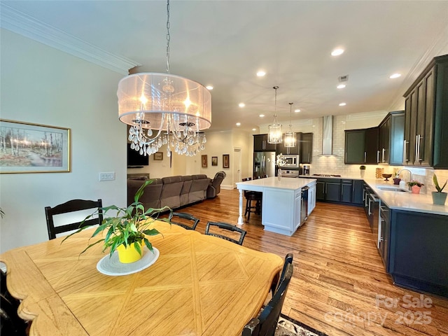 1025 N Sharon Amity Rd, Charlotte, NC 28211 - dining room with a chandelier, light wood-style flooring, crown molding, and recessed lighting