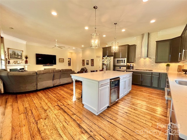1025 N Sharon Amity Rd, Charlotte, NC 28211 - kitchen with wall chimney range hood, appliances with stainless steel finishes, beverage cooler, open floor plan, and ornamental molding
