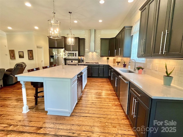 1025 N Sharon Amity Rd, Charlotte, NC 28211 - kitchen featuring wall chimney range hood, a sink, appliances with stainless steel finishes, a breakfast bar, and light wood-style flooring